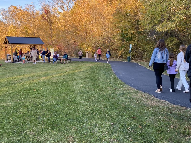 A flickering trail of jack-o-lanterns greets visitors of the Sunset Pumpkin Walk at Meadowbrook Marsh.